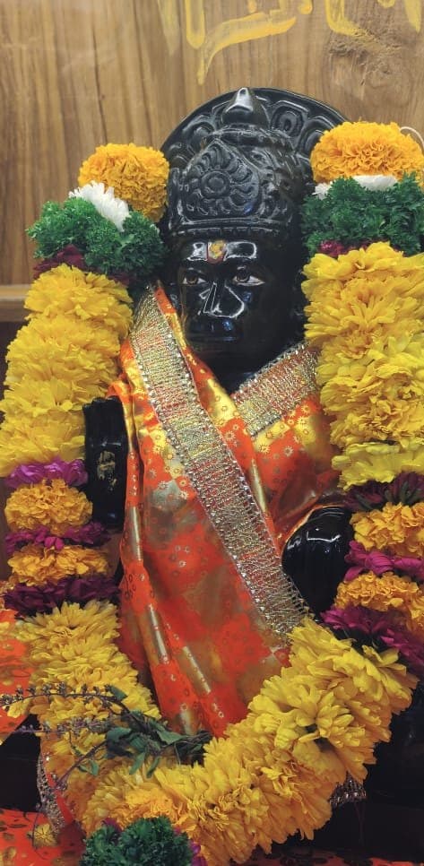Hanuman idol adorned with marigold garlands