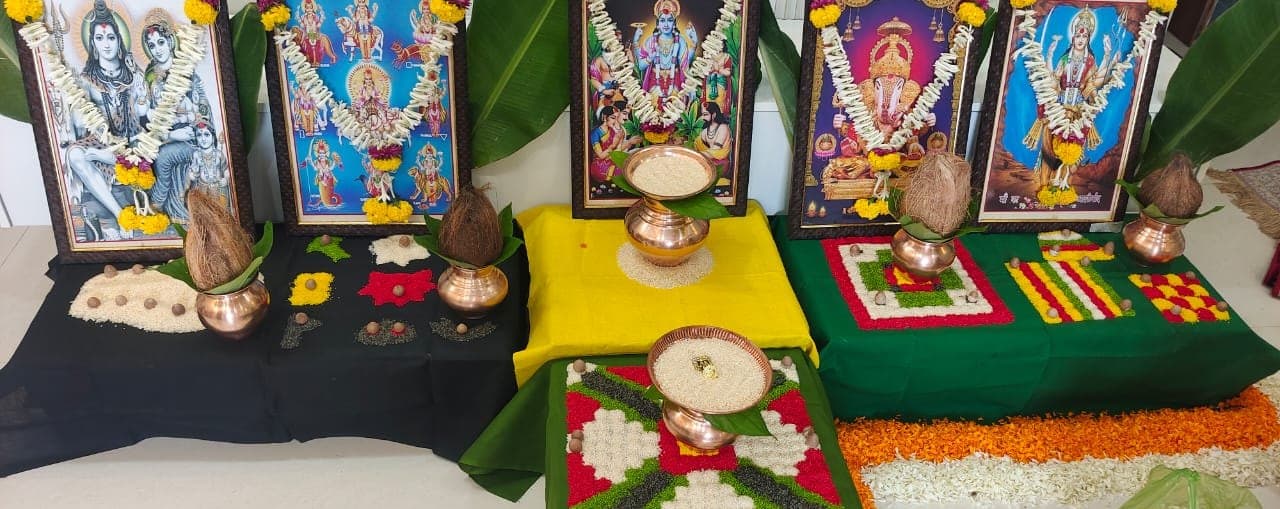 Row of kalash placed before framed deities